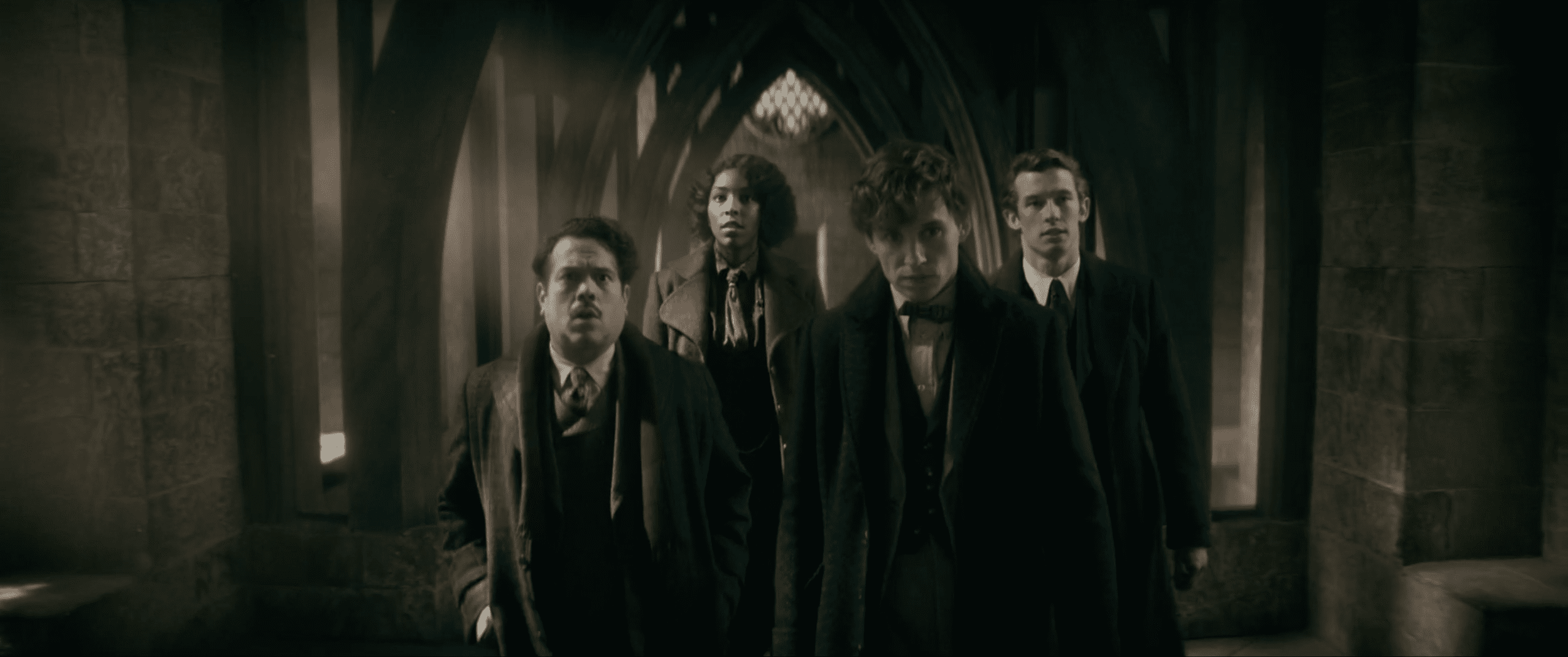New Scamander, Jacob Kowalski, Theseus Scamander, and Lally Hicks walking through Hogwarts